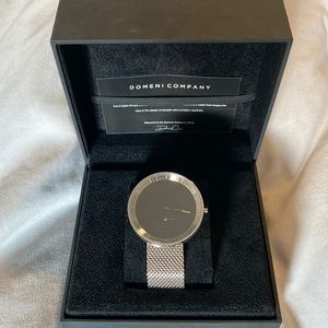 Domeni Company Silver watch with black face.